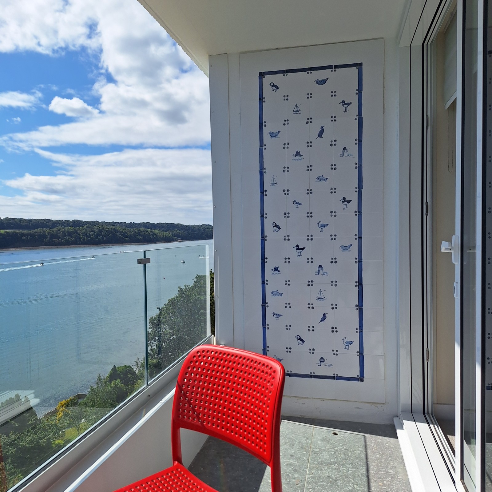 Some hand painted on glaze tiles situated on a seaside balcony