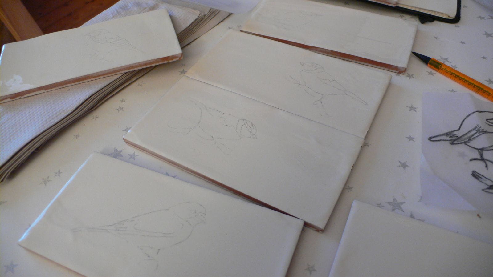 Recent commission - Garden Birds. Here the design is being traced on a glazed tile.
